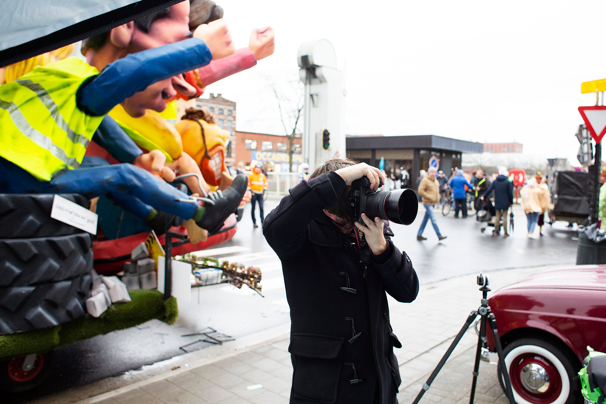 Photograph of Darren Smith behind the scenes, photographing on the streets of Aalst Carnival parade 2020.