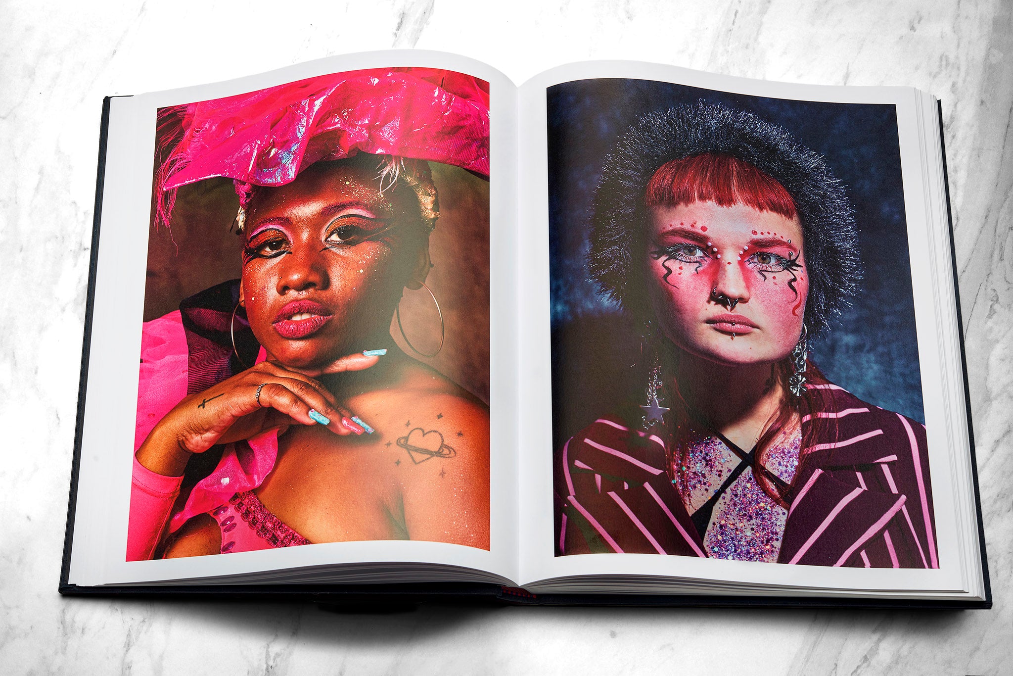 Mayflies book open spread portrait of dark skinned carnivalist frrom Uruguay and portrait of a voguer with a fluffy head piece from Lithuania