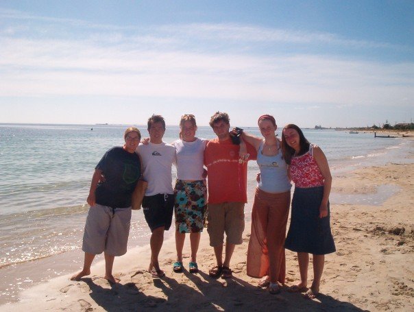 Snapshot of Darren with university friends on a beach in Western Australia on a sunny day