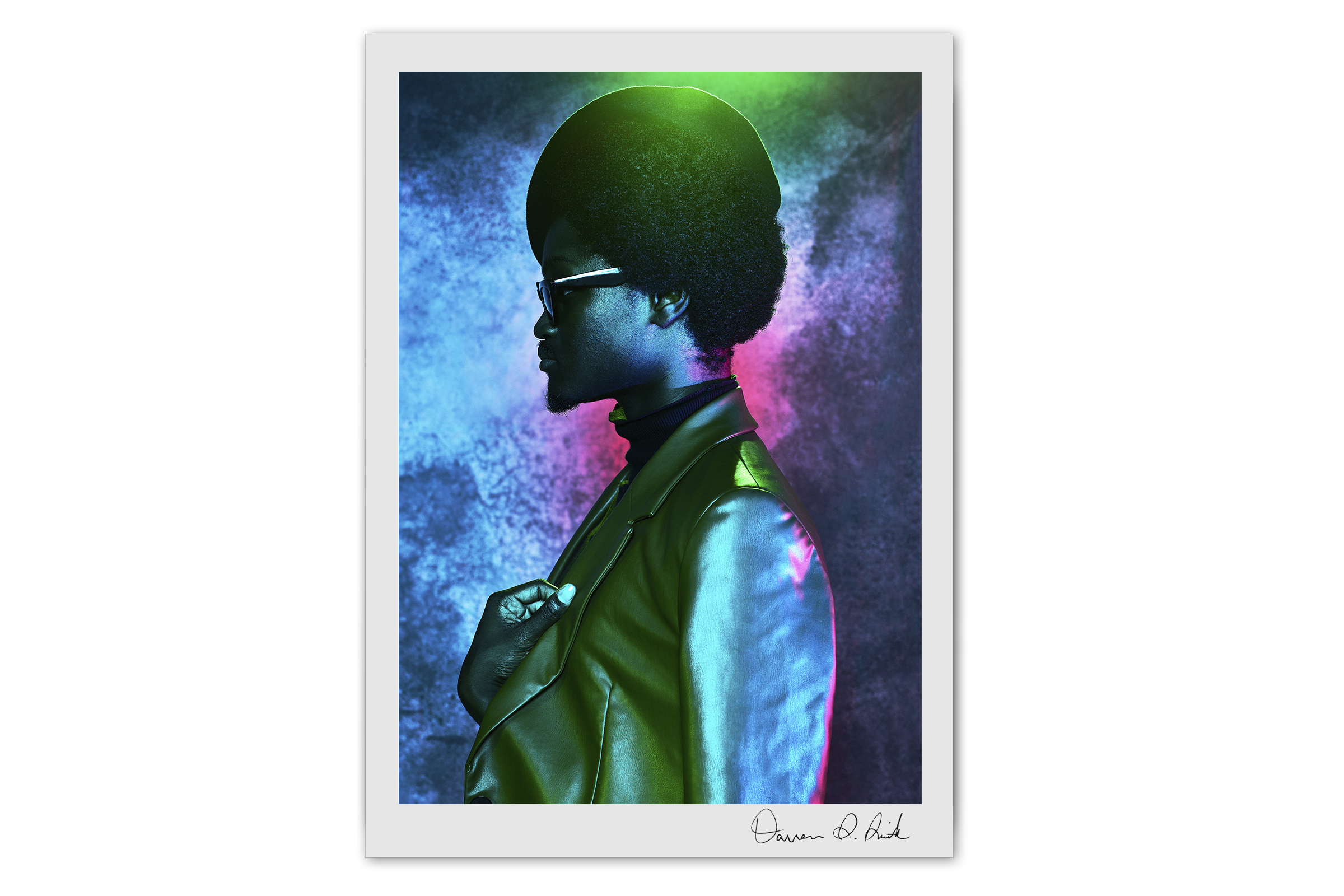 Print Special Edition: Utopia Ball Pt IV, dark-skinned male voguer with a stylish jacket and hat looking off camera with vibrant blue, red, and green lighting reflecting on his clothing and on the studio background